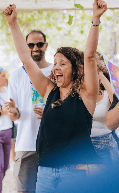 A photo of an Orcan showing excitement with hands raised